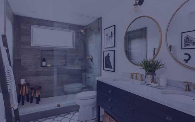 Decorative Bathroom with Two Circle Mirrors, a Shower, Bathroom Sinks and a Toilet in East Auckland.