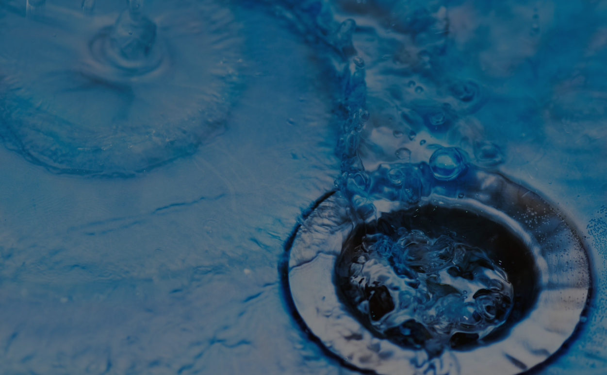Blue Liquid being used for Plumbing Maintenance Down a Drain